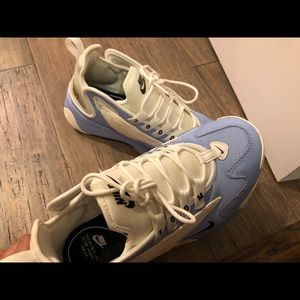 Blue and white Nike zoom 2k